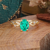 Artistic Twisted Shank Oval Cut Emerald Engagement Ring