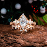 Unique Pear Shaped Engagement Ring Set Moissanite Cluster Wedding Band on wood background with festive decor