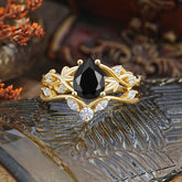Luxury Nature-Inspired Pear Cut Vintage White 4 Prong Black Onyx Ring Pave Engagement Ring Set on decorative surface.