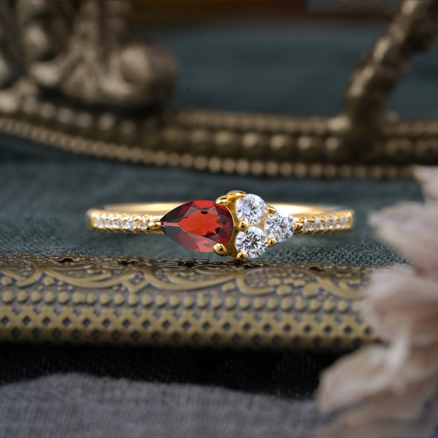 Pear Shaped Garnet Three Round Stone Engagement Ring