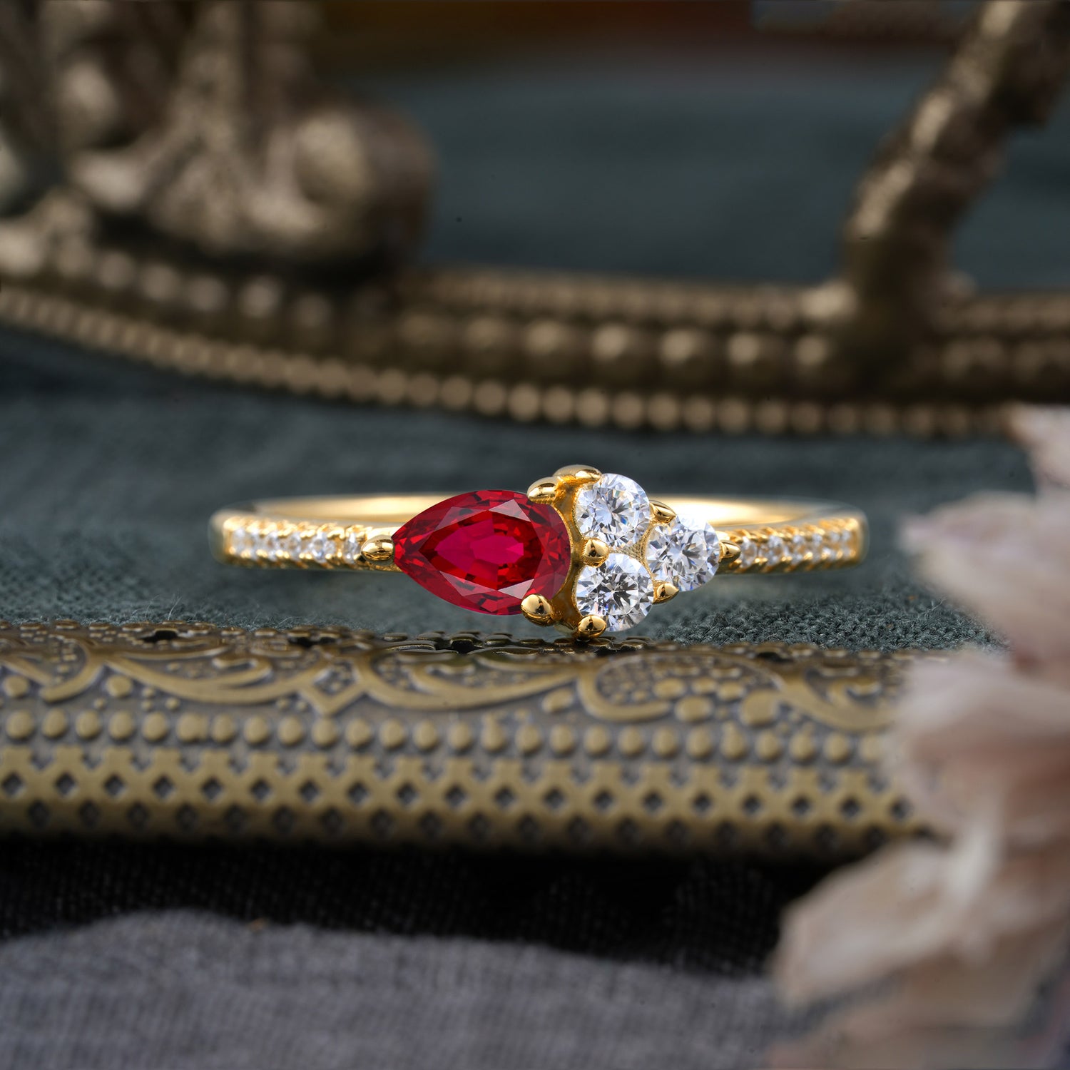 Pear Shaped Ruby Three Round Stone Engagement Ring