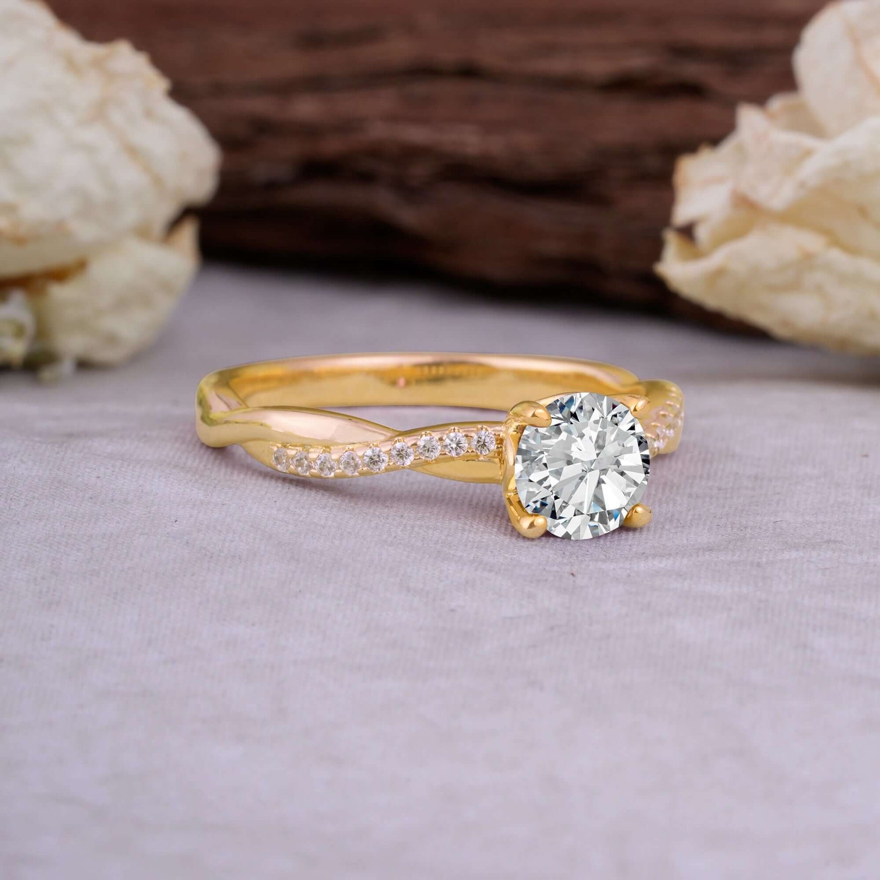Classic Round Cut Lab Diamond Engagement Ring with Twisted Band on a soft surface surrounded by decorative flowers.