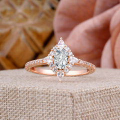 Vintage 4 Prong Oval Cut  Lab Diamond Engagement Ring Cluster Pave Bridal Ring on display with a rose backdrop.