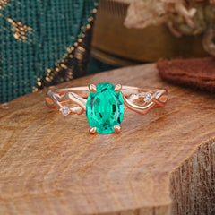 Artistic Twisted Shank Oval Cut Emerald Engagement Ring
