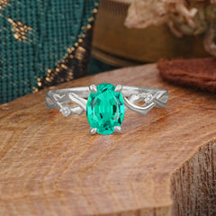 Artistic Twisted Shank Oval Cut Emerald Engagement Ring
