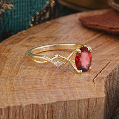 Artistic Twisted Shank Oval Cut Garnet Engagement Ring