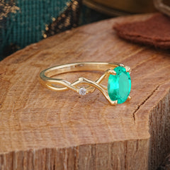 Artistic Twisted Shank Oval Cut Emerald Engagement Ring