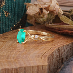 Artistic Twisted Shank Oval Cut Emerald Engagement Ring