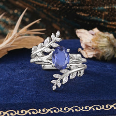 Delicate Leaf Embellished 4 - Prong Oval - Cut Tanzanite Ring Sets