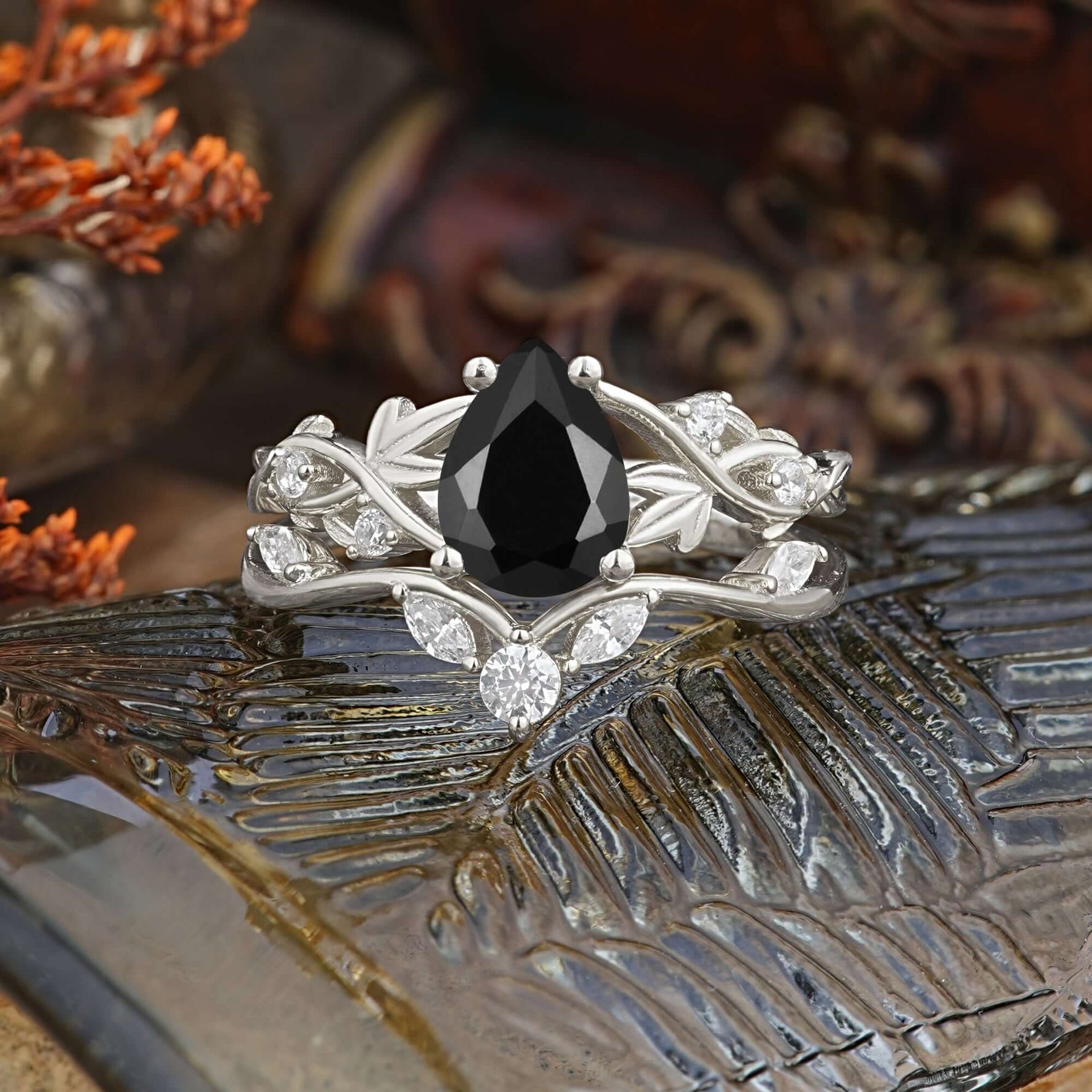 Luxury Nature-Inspired Pear Cut Vintage White 4 Prong Black Onyx Ring Pave Engagement Ring Set on a decorative surface.