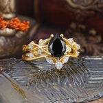 Luxury Nature-Inspired Pear Cut Vintage White 4 Prong Black Onyx Ring Pave Engagement Ring Set on a decorative backdrop.